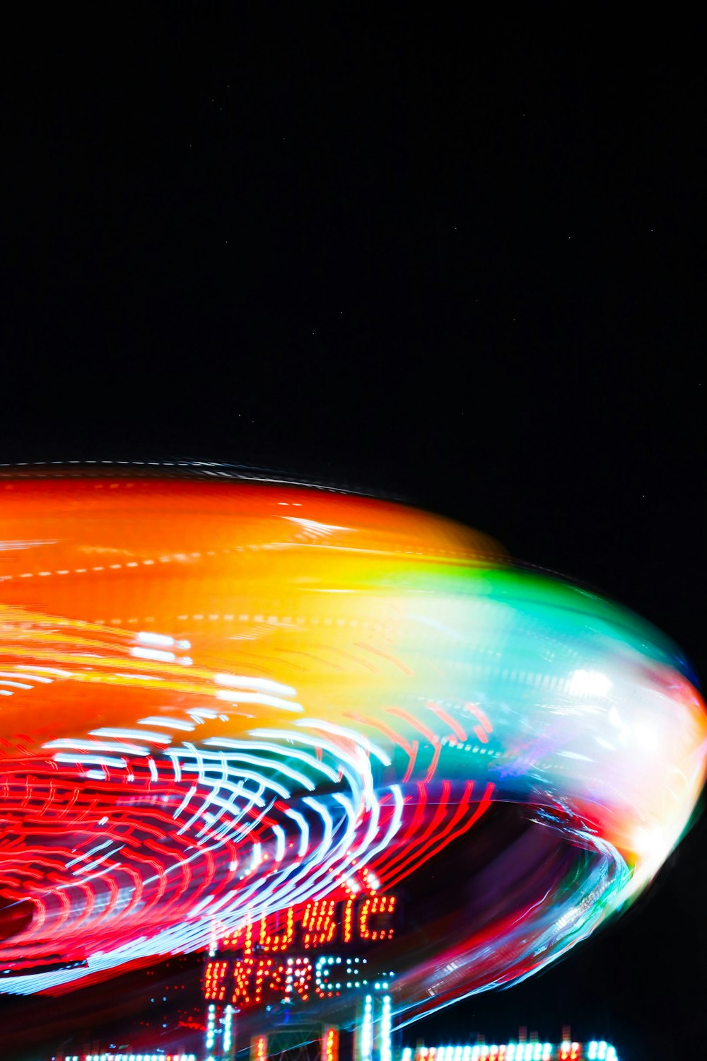 a large colorful object with lights in the dark