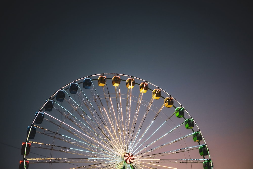 a ferris wheel is lit up at night