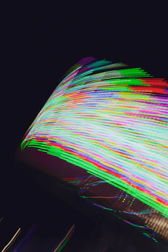 Dynamic shot of colorful sound waves pulsating over a dark background with neon gradients, capturing the energy of a lively party.