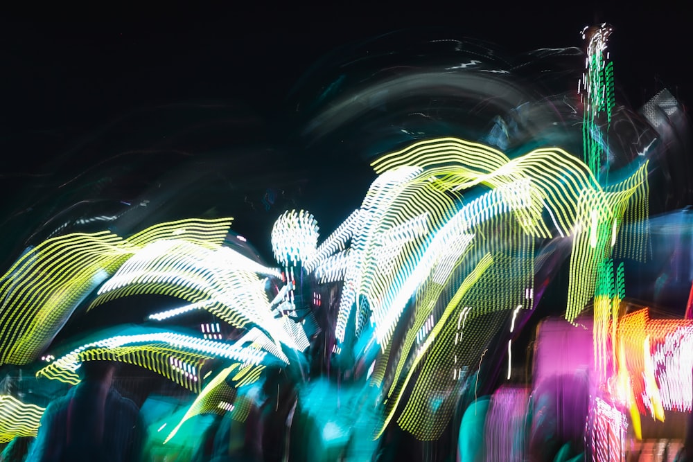 a blurry photo of a carnival ride at night