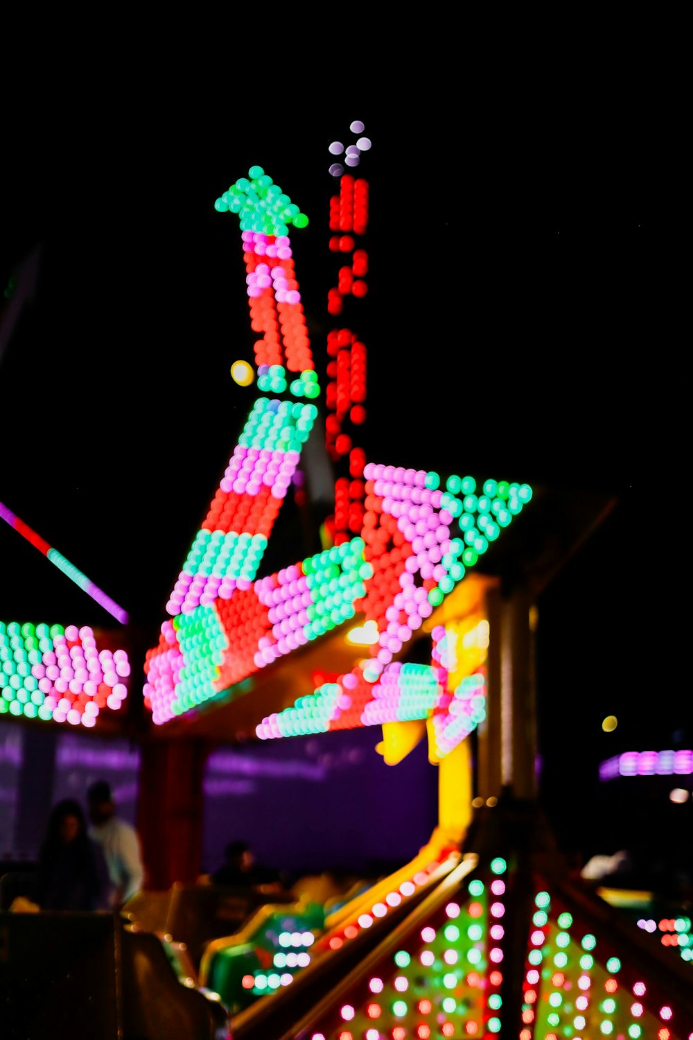 a close up of a carnival ride at night
