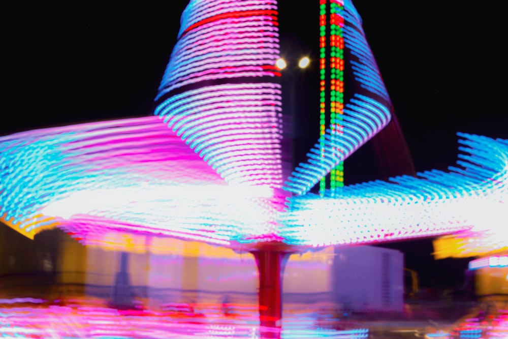 a blurry photo of a carnival ride at night