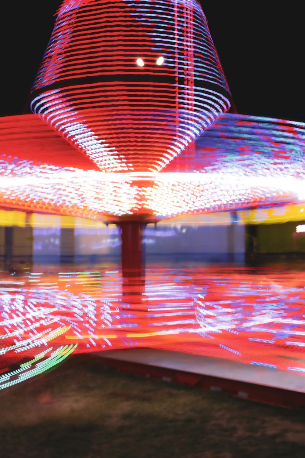 a blurry photo of a carnival ride at night