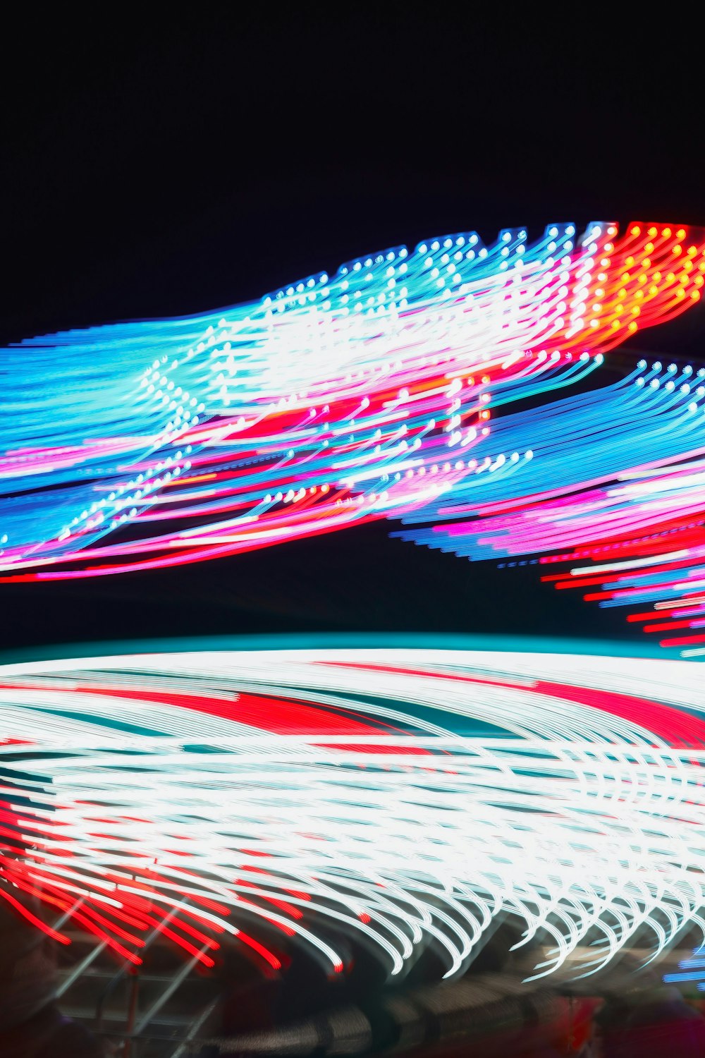 a blurry photo of a ferris wheel at night