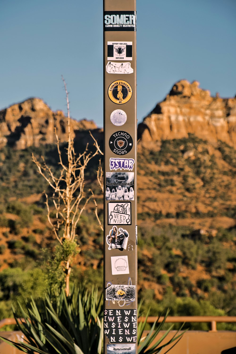 a pole with a bunch of stickers on it