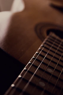 Detailed shot of the intricate wood grain and craftsmanship on a Marcam acoustic guitar