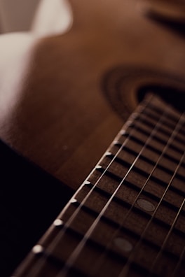A close-up of a beautifully crafted wooden guitar.