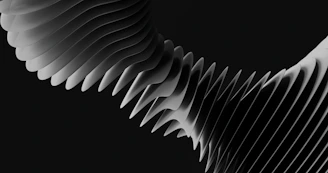 A series of stacked grey discs forming a curved abstract shape on black