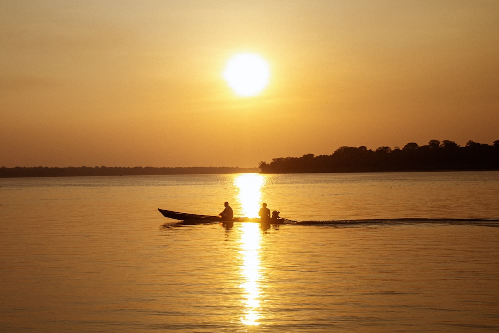 a couple of people in a boat on a lake