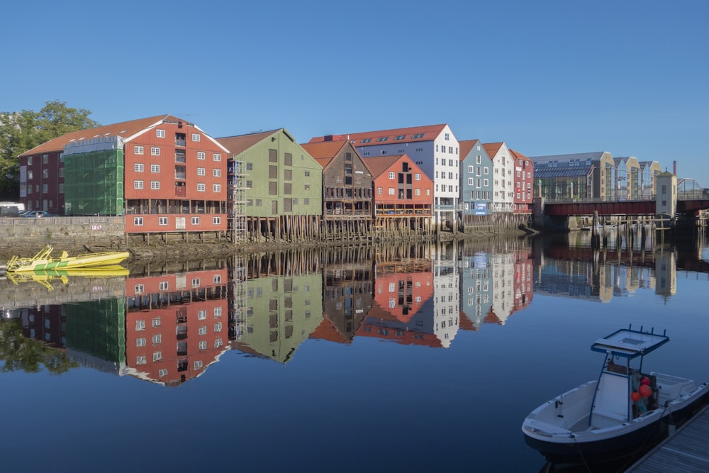 a row of houses sitting next to a body of water