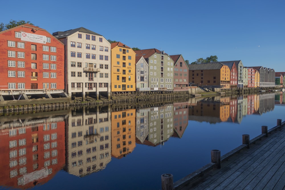 a group of buildings sitting next to a body of water