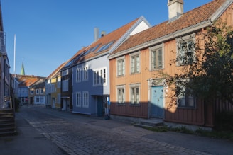A charming street in Sant Cugat del Vallès lined with traditional Catalan homes under a clear blue sky
