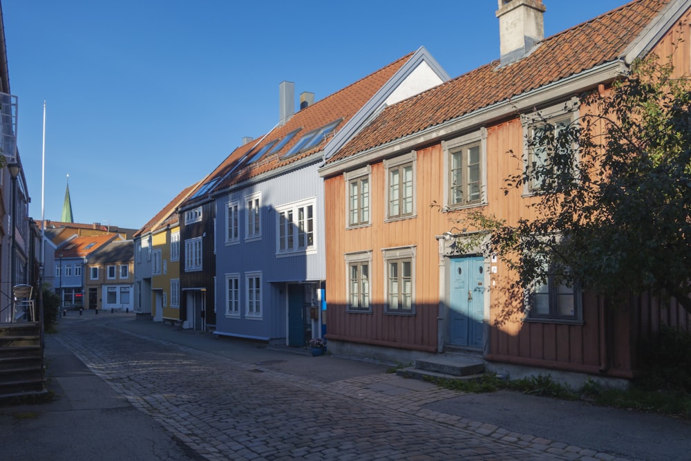 a cobblestone street lined with wooden buildings