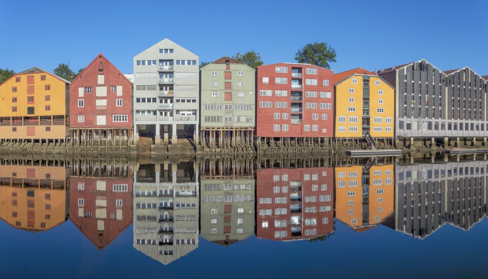a row of houses sitting next to a body of water