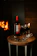 A cozy wine tasting setup with glasses and a bottle on a wooden table.