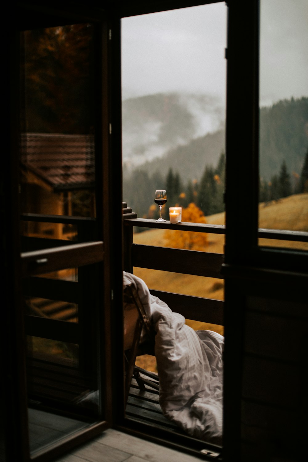 a person laying on a bed in front of a window