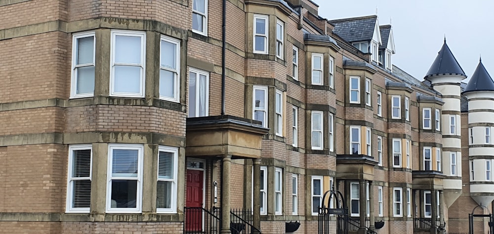 a row of brick buildings with a red door