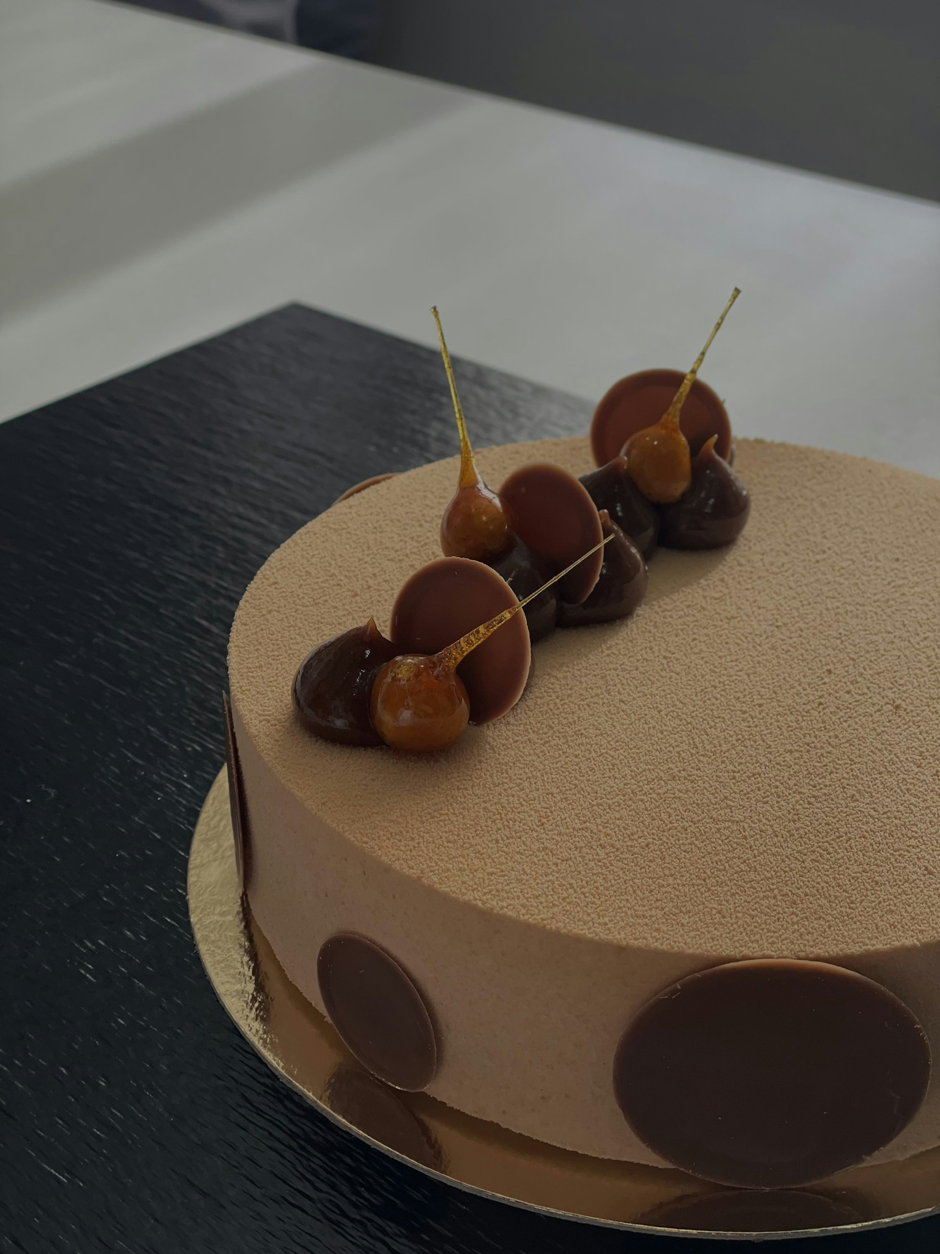 An elegant cake shaped as a luxury watch face, featuring delicate sugar hands and shimmering gold accents.