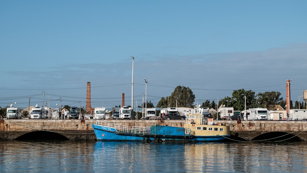 a blue and yellow boat sitting in the water