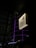A sign with a simple illustration of a person using chopsticks is prominently displayed on a building. The background features a curved structure with purple neon lights outlining its design, giving a modern and vibrant atmosphere.