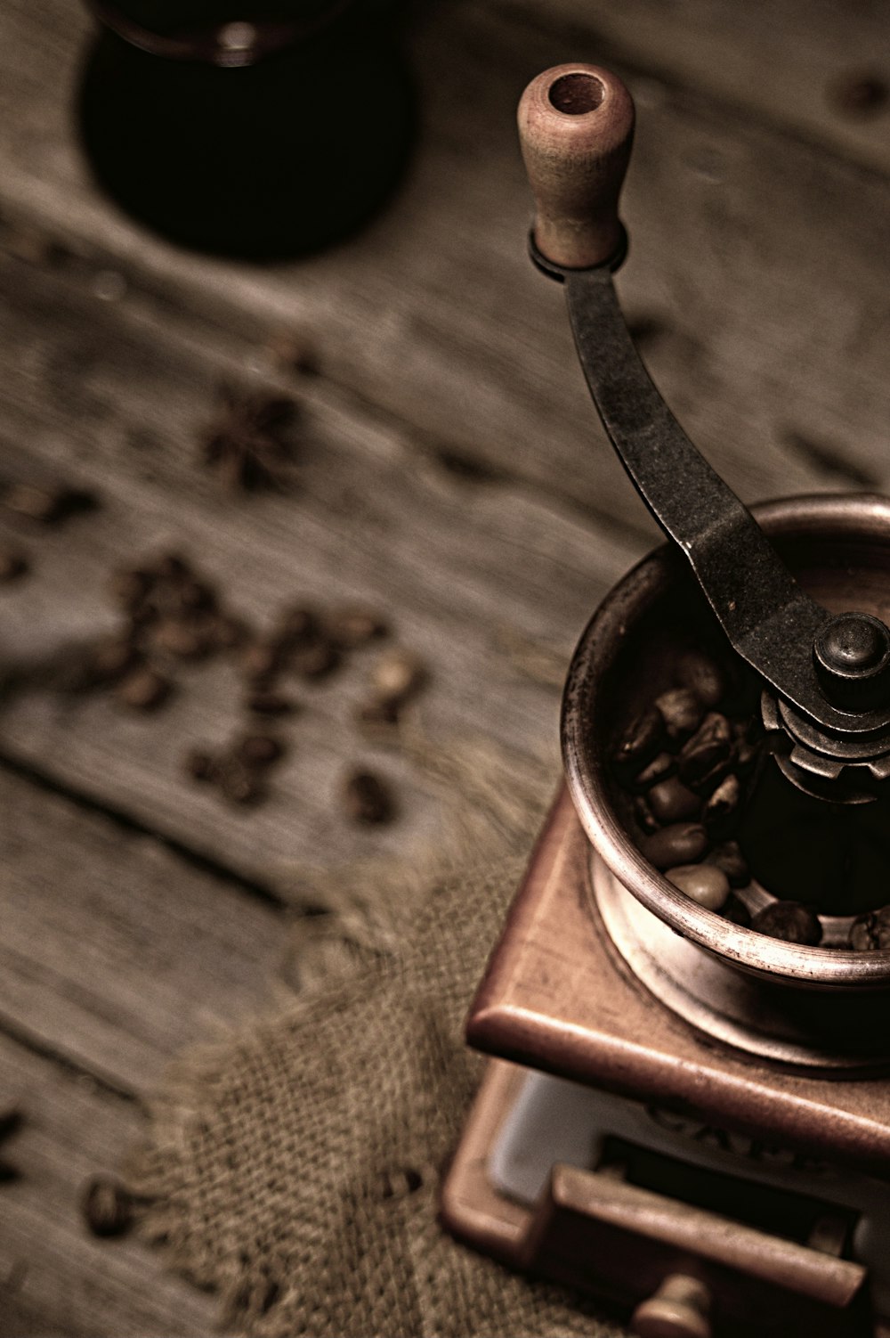 a coffee grinder sitting on top of a wooden table