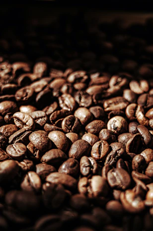 Close-up of roasted Colombian coffee beans in a burlap sack with warm lighting