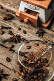 A rustic coffee grinder next to a freshly brewed cup, evoking a warm morning ritual.