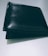 A closed black leather wallet is placed on a flat, light-colored surface. The wallet appears to have a smooth texture with some shine reflecting off its surface.