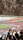 A group of diverse football fans cheering in a stadium.