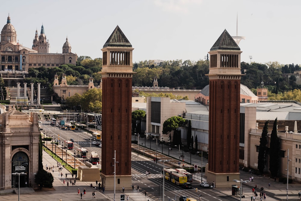 a couple of tall clock towers sitting next to each other