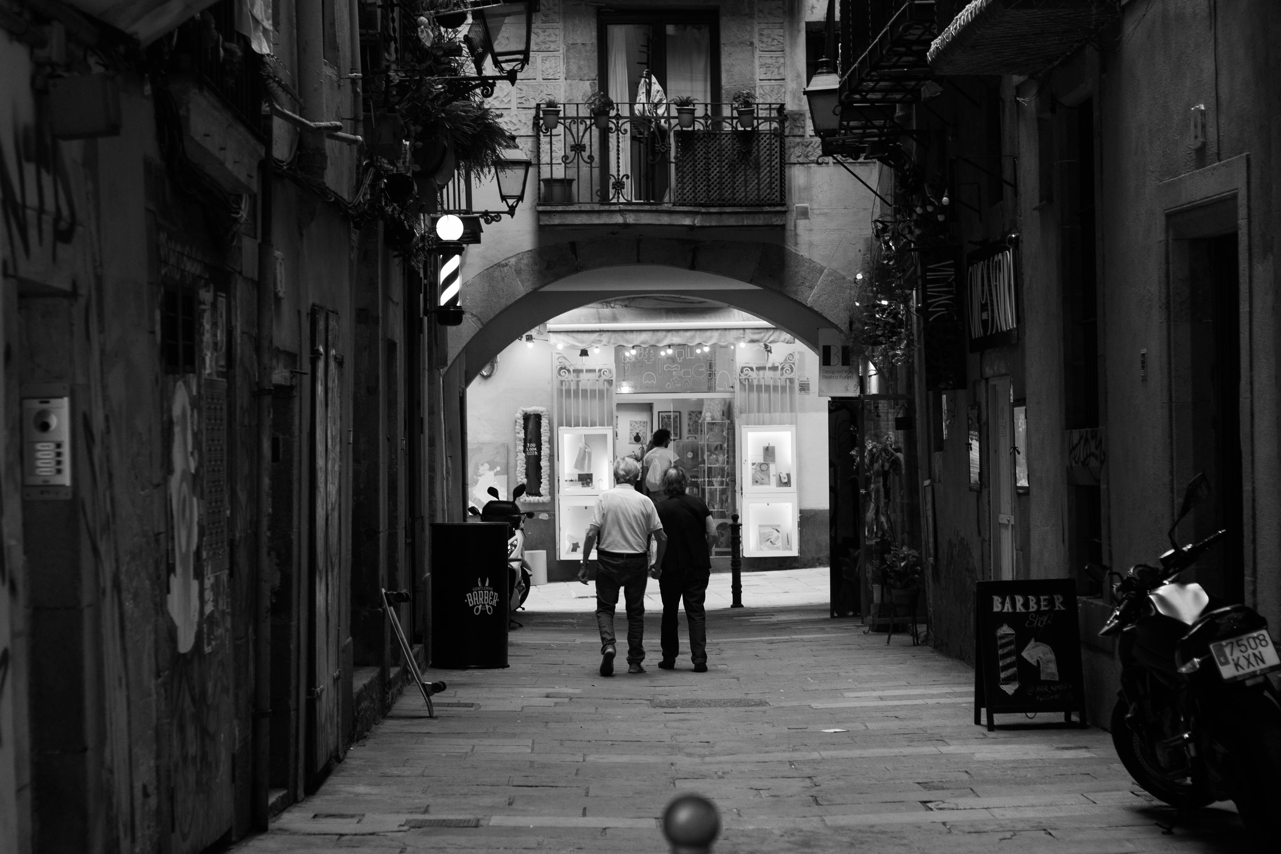 a couple of people that are walking down a street