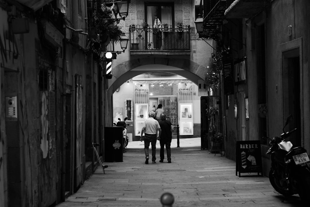 a couple of people that are walking down a street