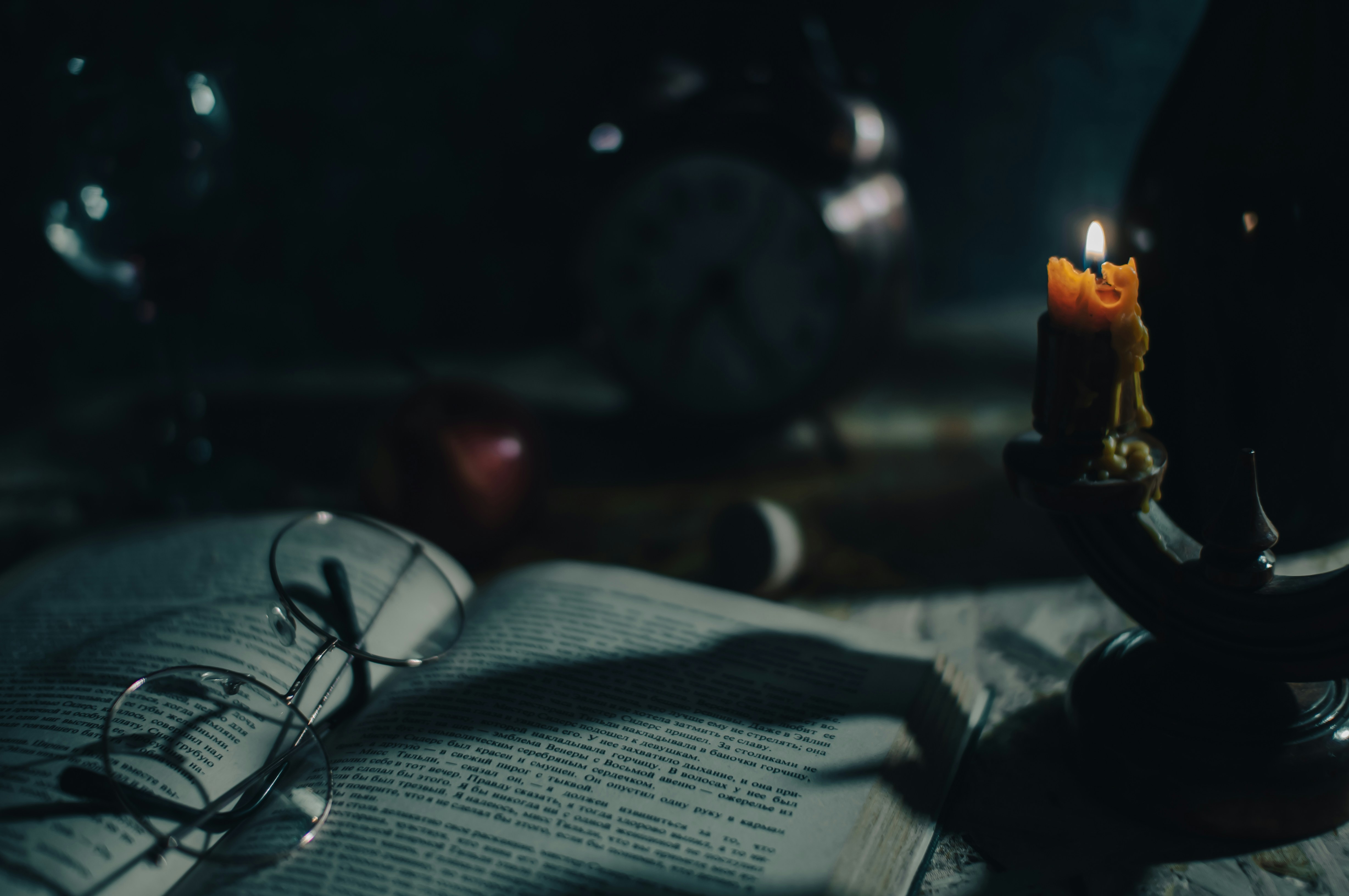a lit candle sitting on top of an open book