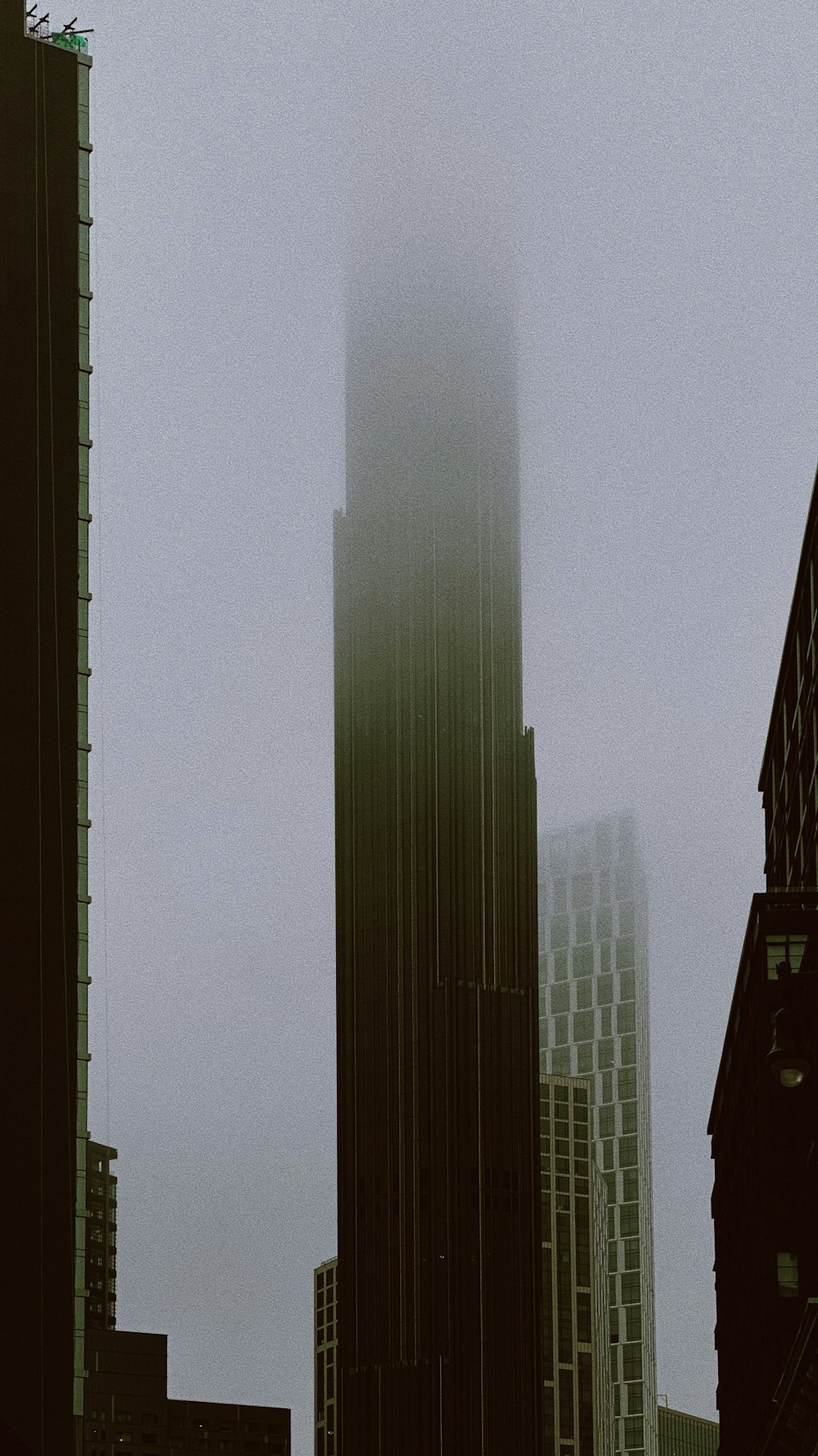 a very tall clock tower towering over a city