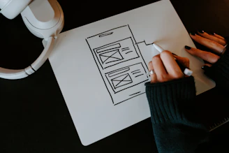 a person writing on a piece of paper