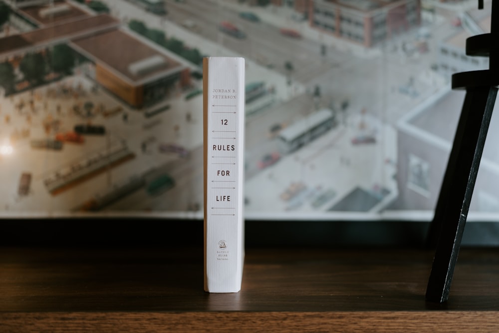 a tall white tube sitting on top of a wooden table