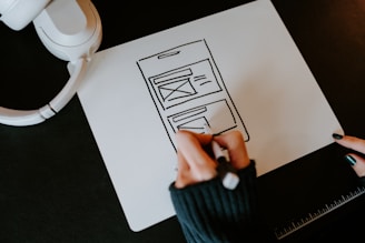 a person drawing a picture on a piece of paper