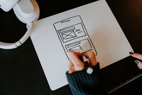 a person drawing a picture on a piece of paper