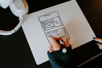 a person drawing a picture on a piece of paper