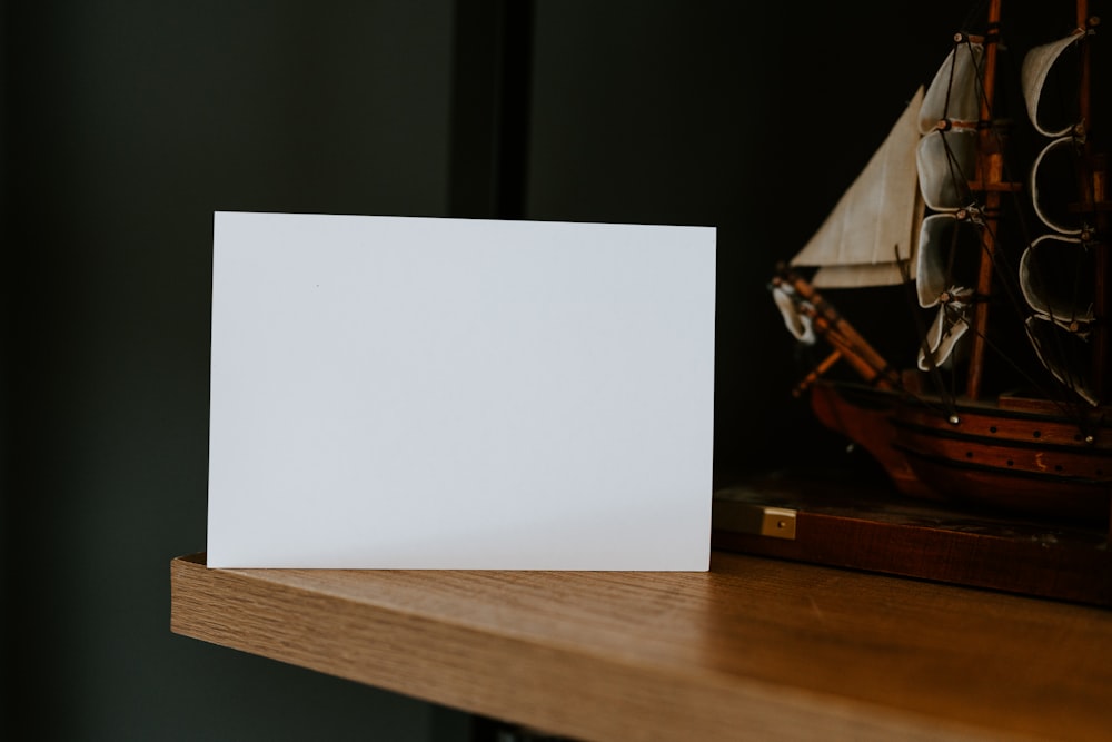 a white card sitting on top of a wooden shelf