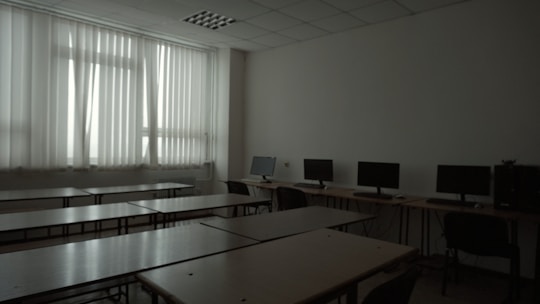 A spacious computer lab with rows of computers ready for online exams.