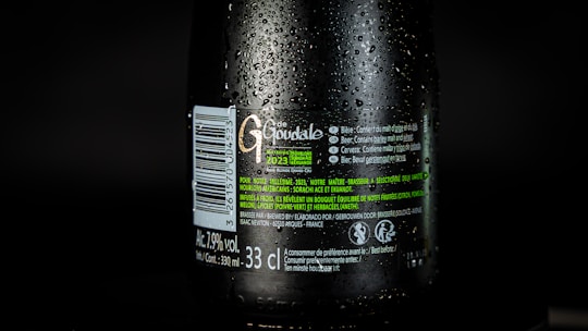 Close-up of a frosty Topvar 12% lager bottle with condensation droplets.