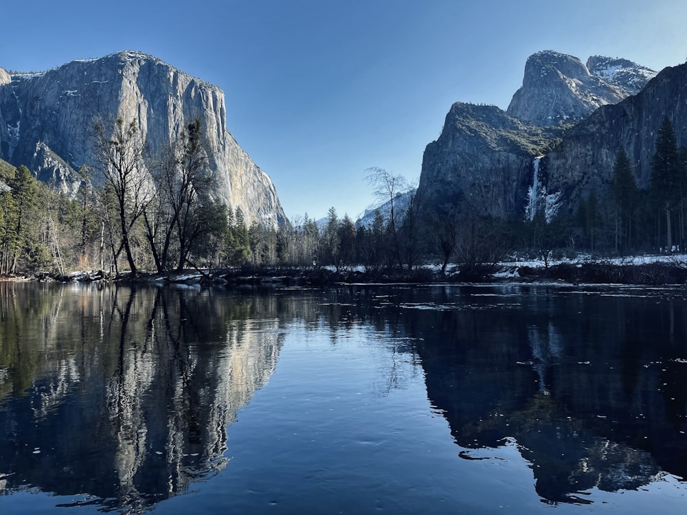 a body of water surrounded by mountains and trees