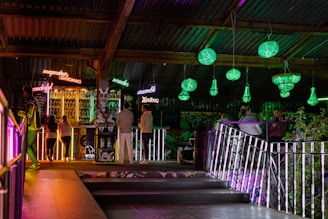 A lively scene inside Madagaska Bar & Grill with guests enjoying colorful dishes and warm lighting.