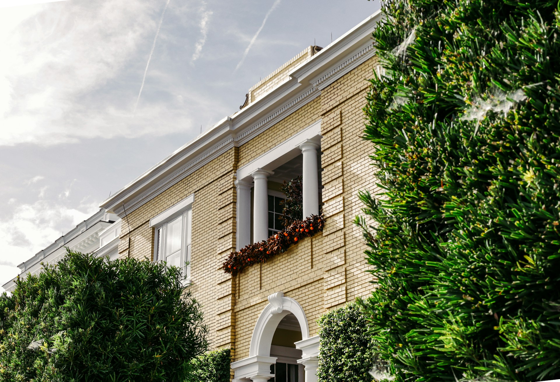 woman wearing yellow long-sleeved dress under white clouds and blue sky during daytime