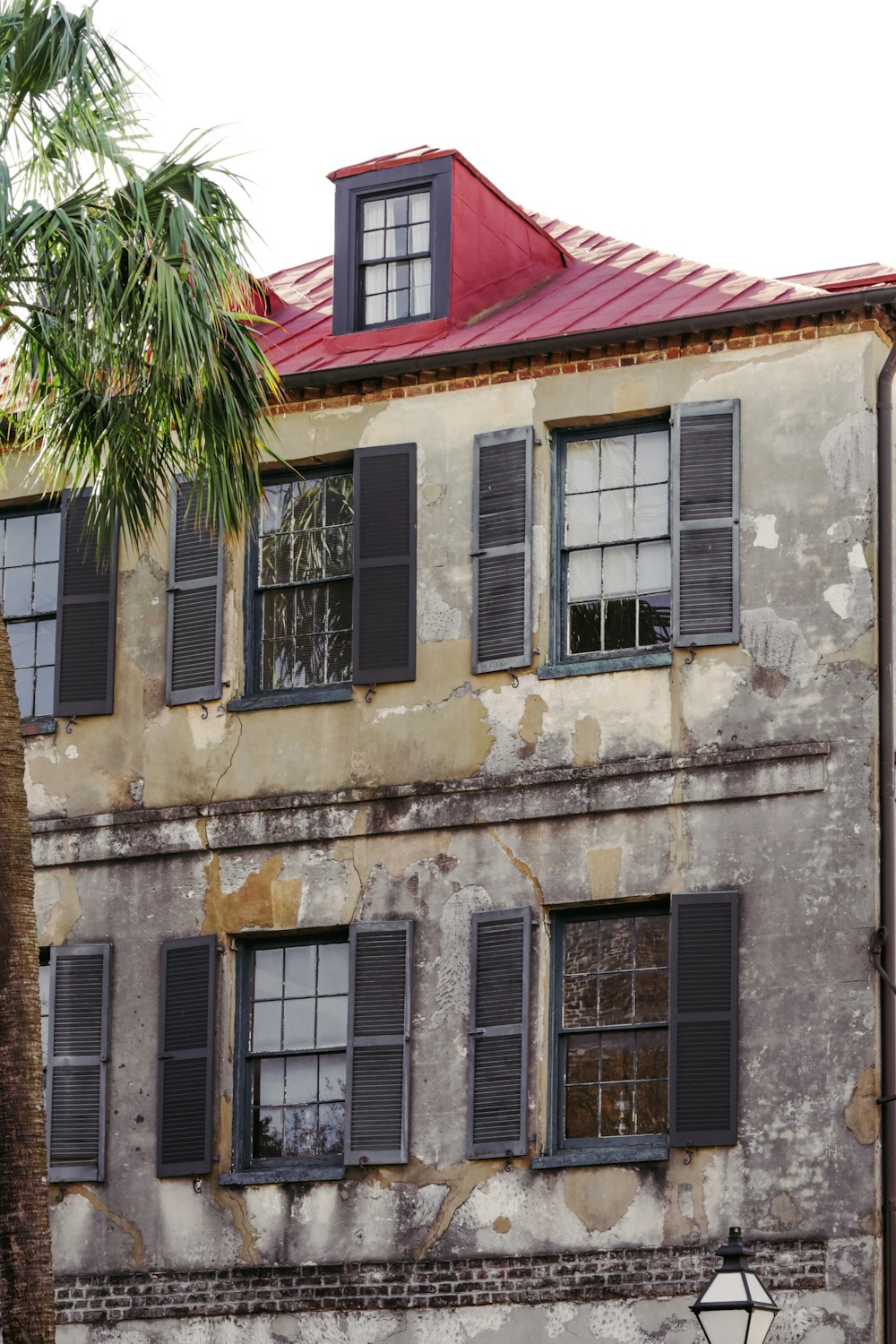 an old building with windows and a red roof