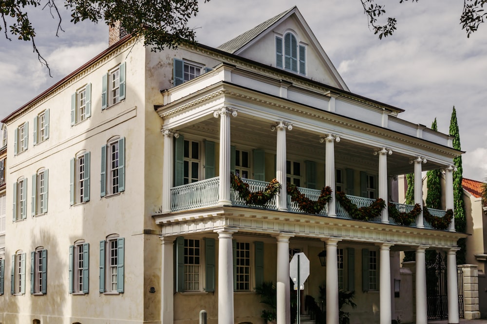 a large white house with columns and wreaths on the porch