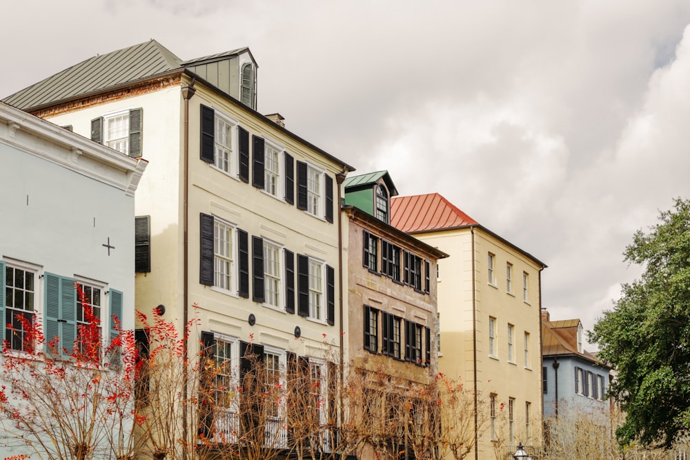 a row of multi - story buildings with a cloudy sky in the background