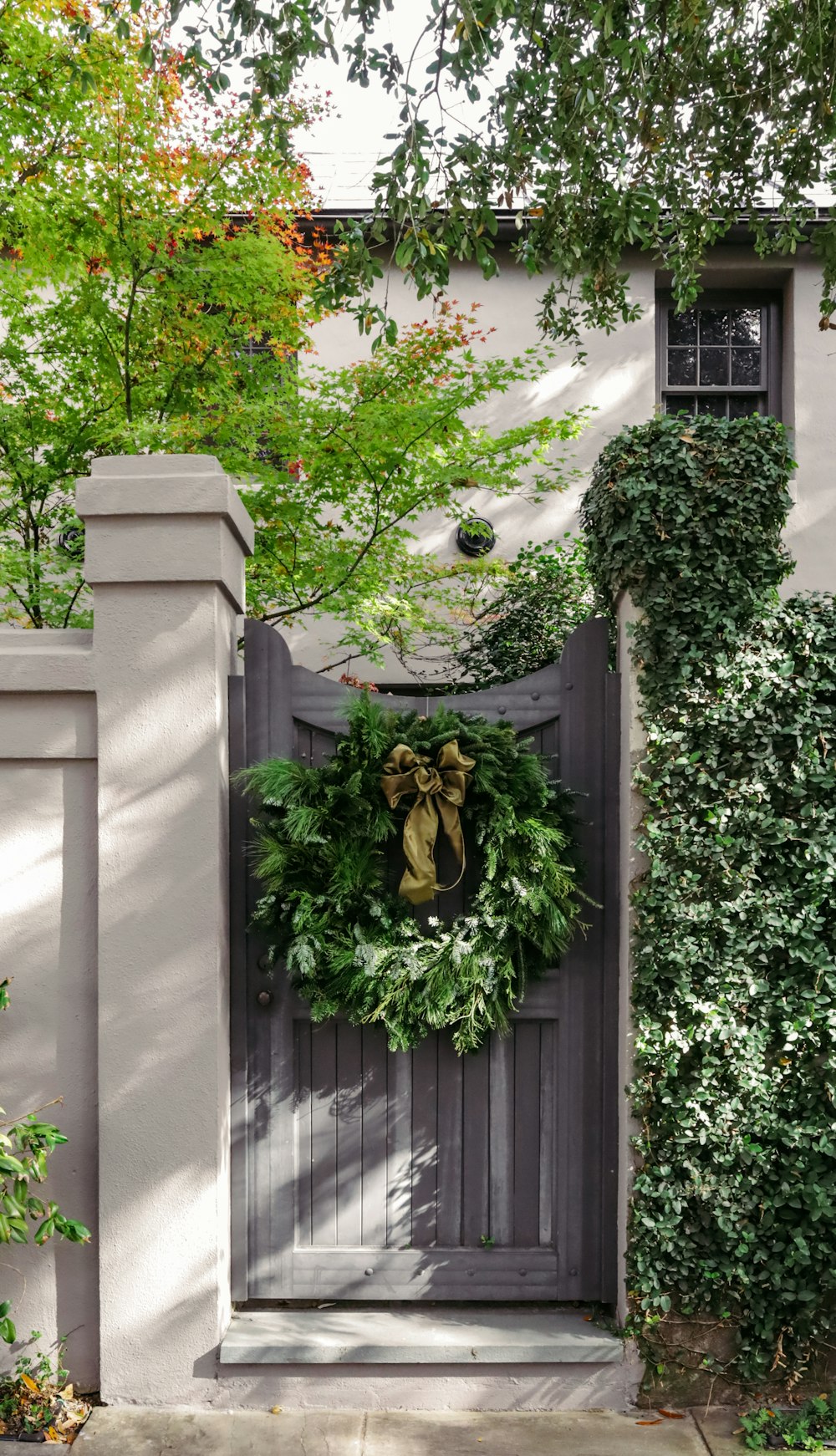 a wreath is hanging on the front door of a house