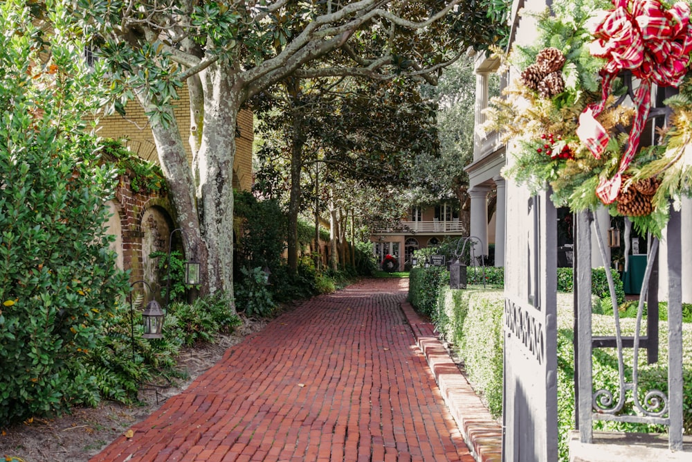 a brick path with a wreath on the side of it